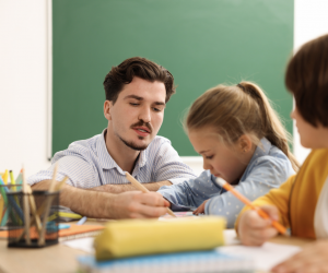 teacher helping a student in class