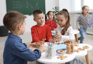 three children working on a table activity together