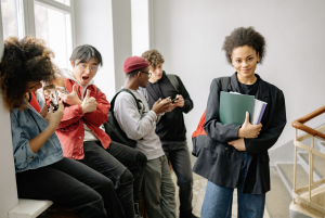 A group of teenagers at the top of a stairwell in a college