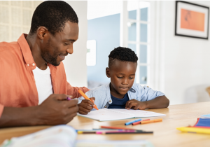 An adult helping a child with homework.