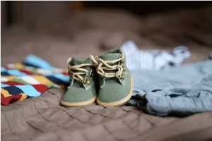 A set of baby shoes on a blanket