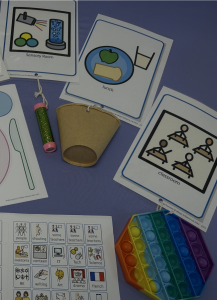 A sensory tube attached to a picture of a sensory room. A cup attached to a picture of a lunch time. A pop it toy attached to a picture of the classroom.