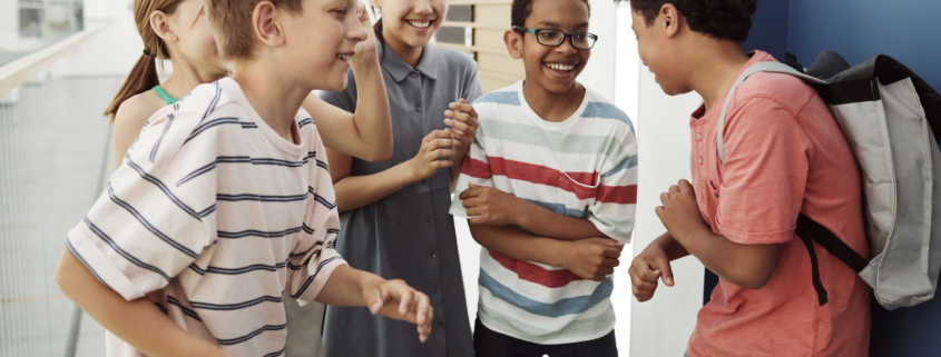 three boys and two girls in a school playground